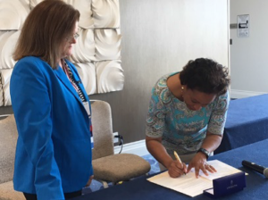Terri Bennett and Carroll Thomas sign the Memorandum of Understanding.